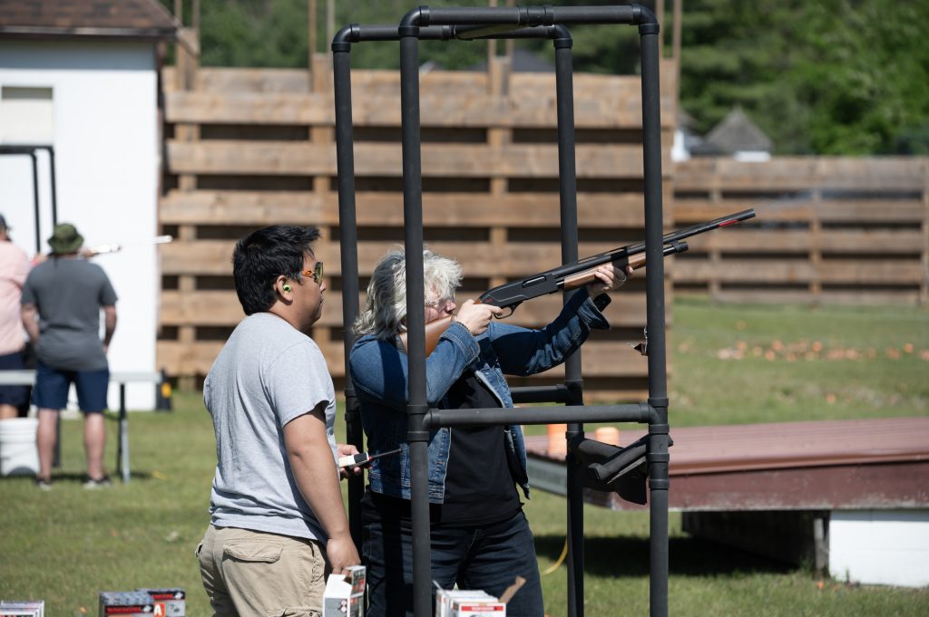 range officer supervising a participant shooting a shotgun